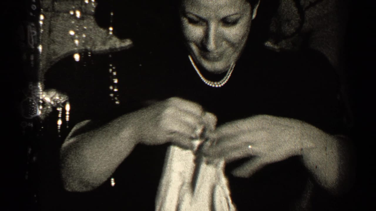 Woman smiles while working her hands through a light fabric garment.