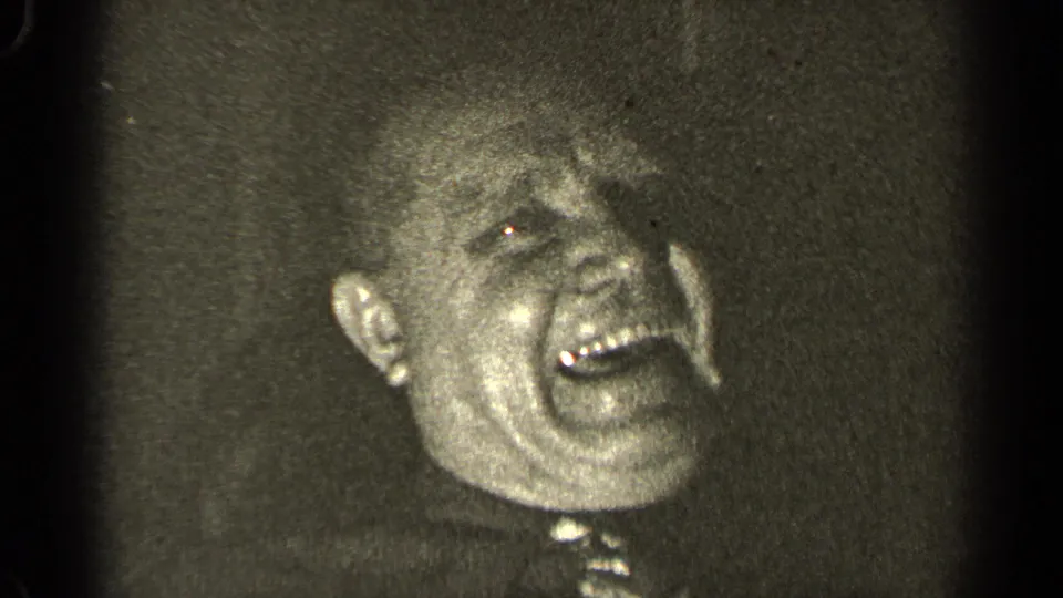 In the 1947 Illinois 8mm clip, the older man laughs broadly, with his face brightly catching the camera light.