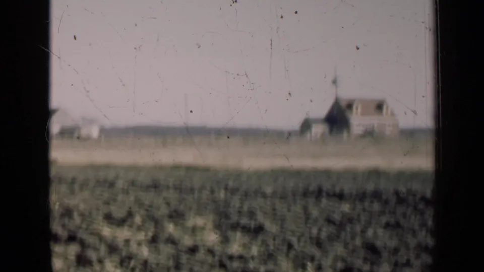 1947 Illinois rural landscape with a farmhouse-like building and smaller structure beyond the field.