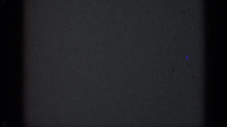 The lower contact-sheet frame is largely dark and underexposed, showing faint film texture and little readable subject detail.