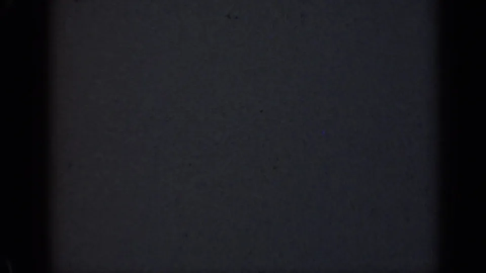 The final extracted frame appears mostly dark, with blue-black exposure and minimal visible scene detail from the 8mm scan.