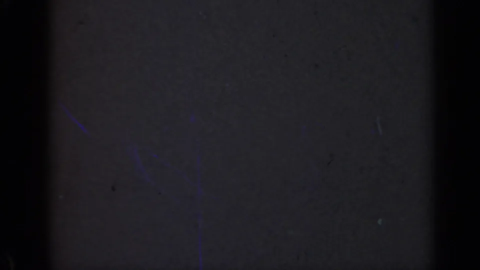 1947 Illinois 8mm frame that appears almost entirely dark, with a central black band, edge shadowing, and faint film speckles.