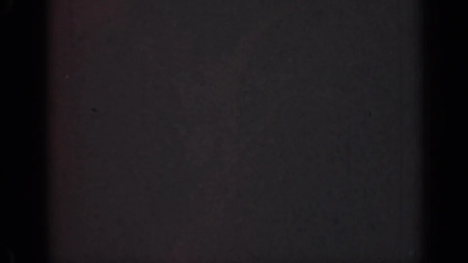 1947 Illinois 8mm home-movie frame showing near-total darkness with faint film grain and dark vertical banding.