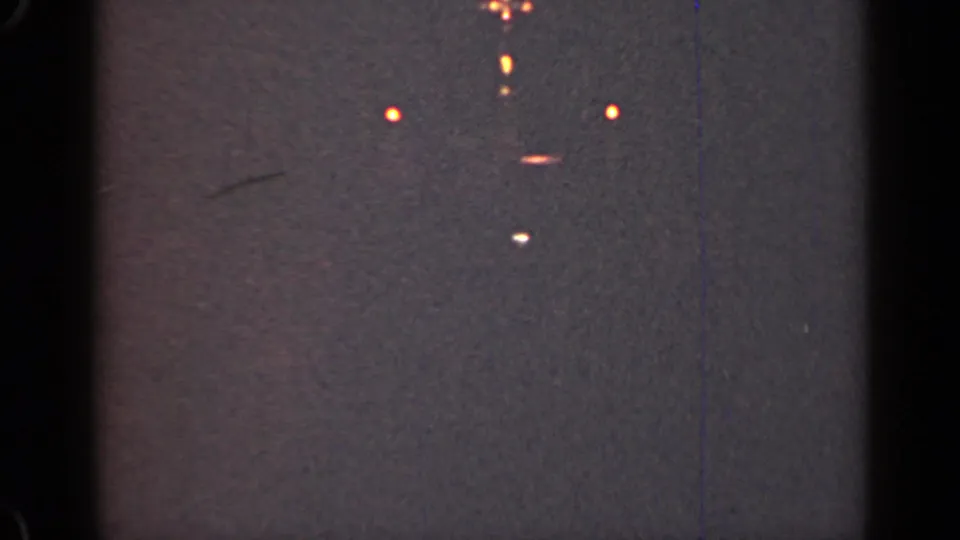 1947 Illinois 8mm frame showing scattered distant lights in a dark, grainy night scene with black film edges.