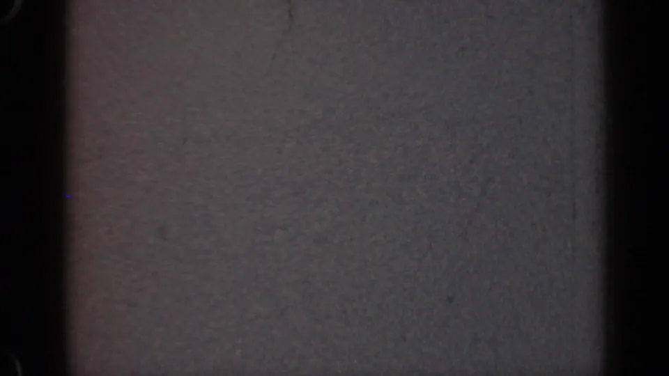 1947 Illinois 8mm frame showing an abstract gray screen-like field with dark vertical bands, grain, dust, and soft exposure variation.