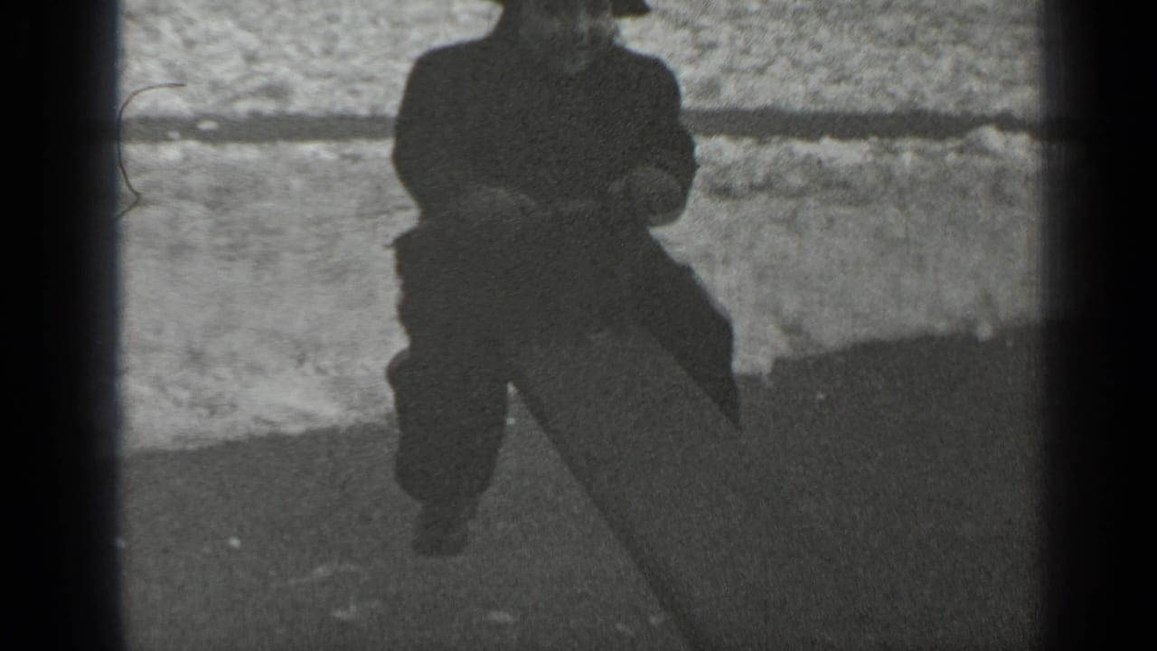 Child riding the raised end of a seesaw near snowy ground.