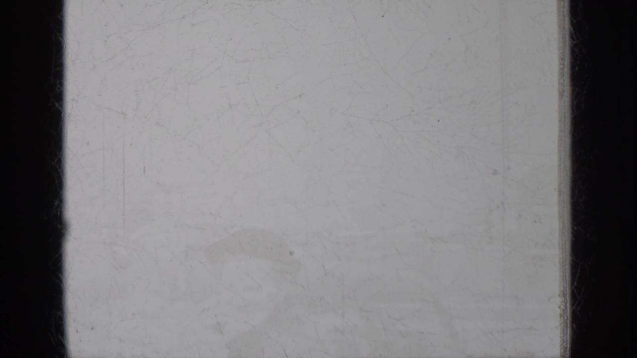 Pale scratched frame with faint horizontal exterior shapes.