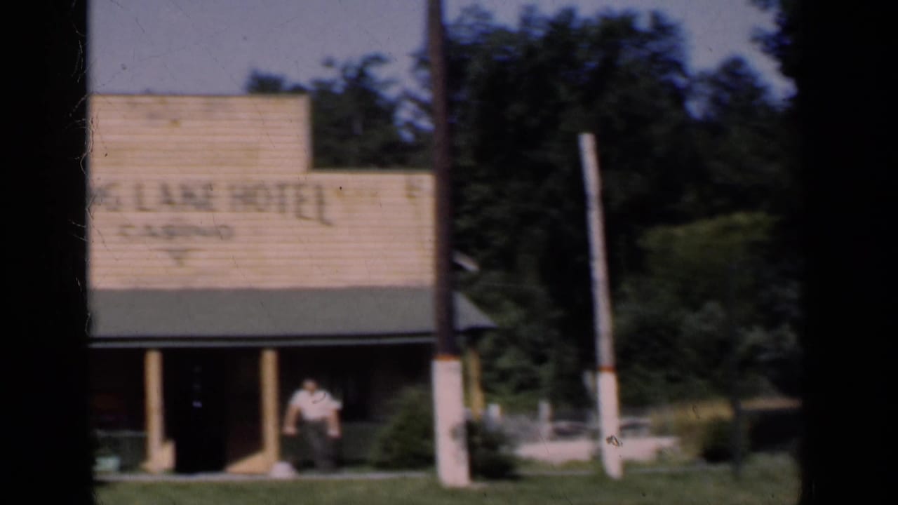 Hotel building with a large Spring Lane Hotel sign and a man standing near the entrance.