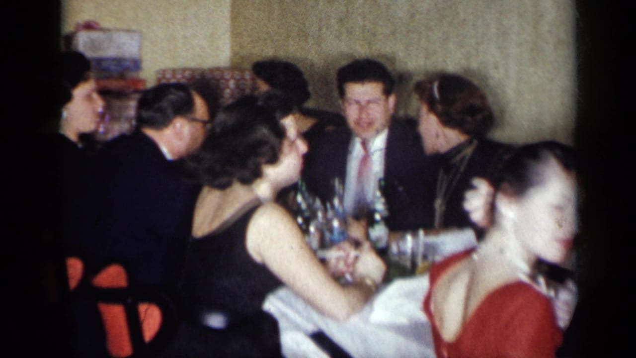 Adults seated at a restaurant table during a formal dinner gathering.