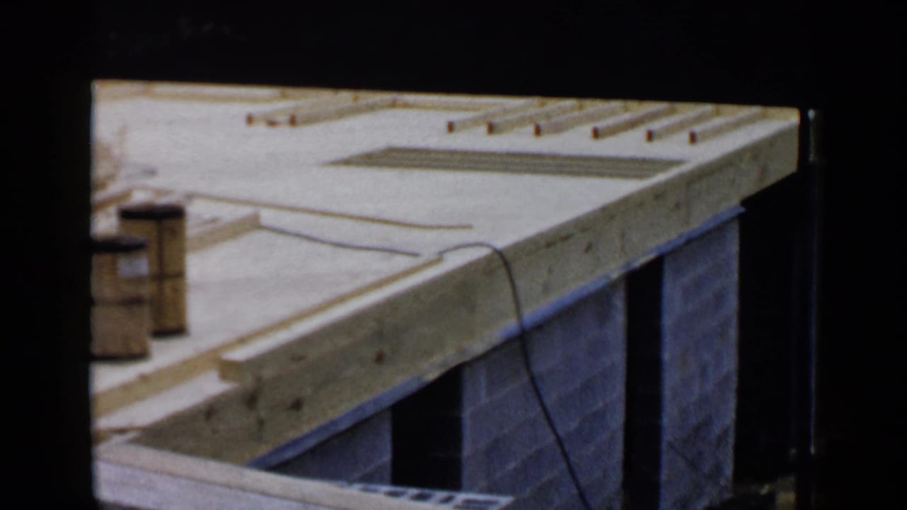 Wooden joists and cinder block walls at a construction site.