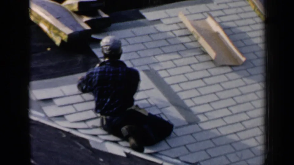 Another worker kneels on the Birmingham roof near loose shingles and stacked roofing material, seen from behind in the final frame.