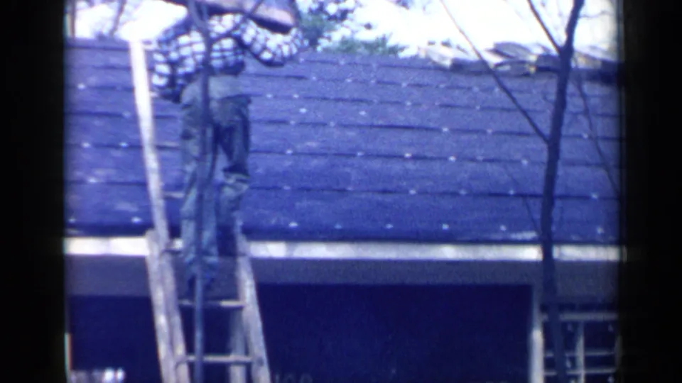 The final frame shows the man high on the ladder near the blue roof, partly obscured by branches and film exposure variation.
