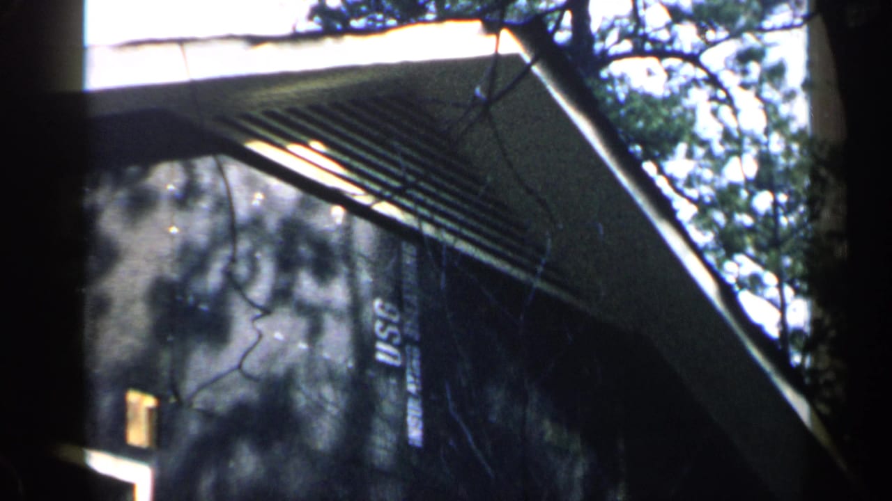 Similar exterior angle on a house wall with eaves, trees, and USC lettering.