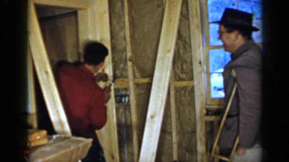 The final frame shows the red-shirted man using his hands near the doorway frame as the hat-wearing man with crutches watches from the right.