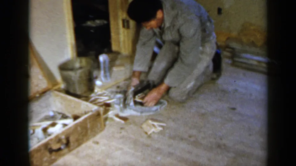 The final frame shows the Birmingham worker kneeling over a dark tool or material during a basement-like construction task.