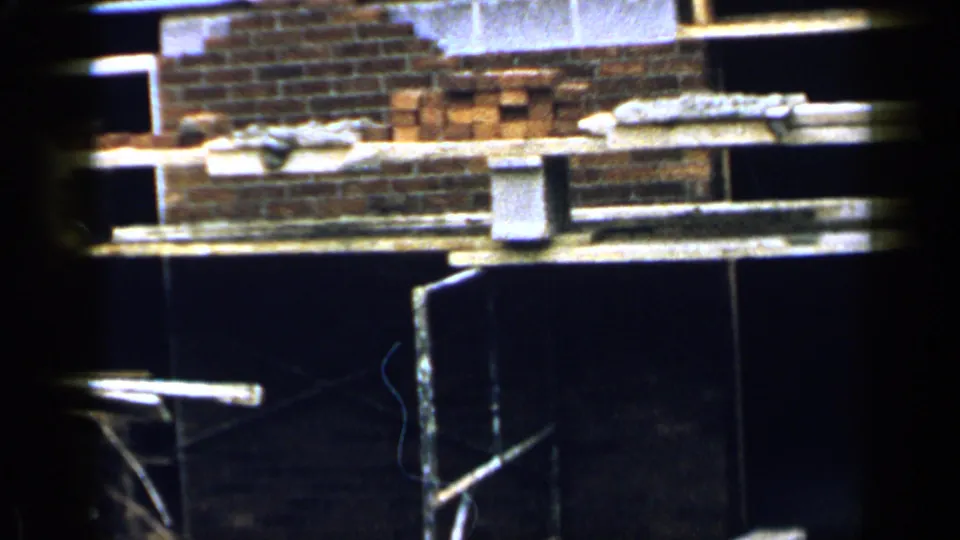 A partially built brick wall and scaffold planks appear in the Birmingham construction scene, with stacked bricks and buckets visible.