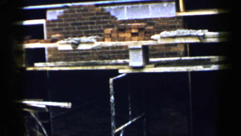 The 1957 Birmingham construction view shows brickwork, scaffold planks, buckets, and a partial worker figure at the frame edge.