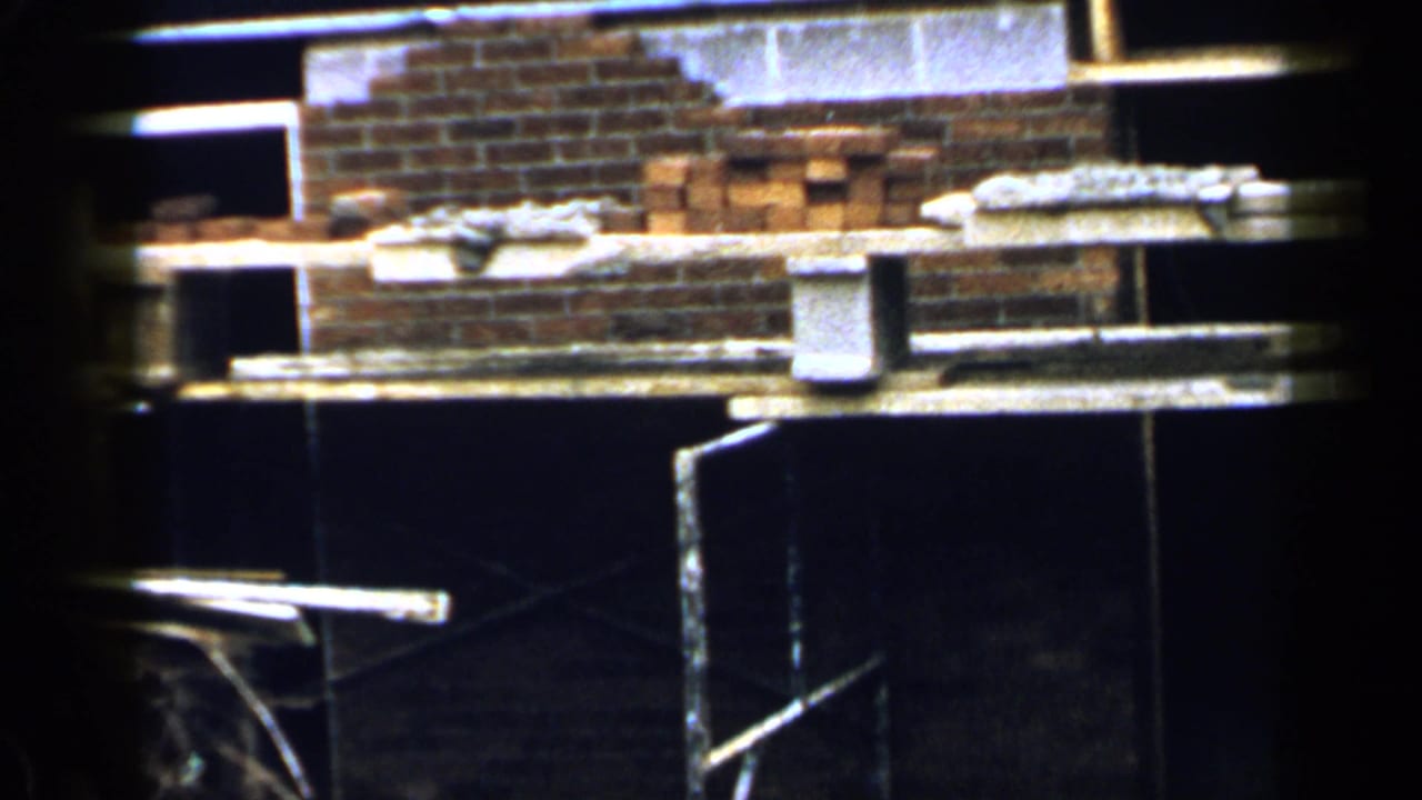Stacks of bricks and concrete blocks inside a dim construction area.