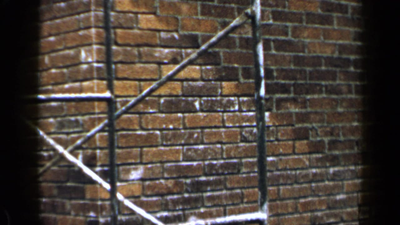 Brick wall corner with metal scaffolding and dark 8mm frame edges.