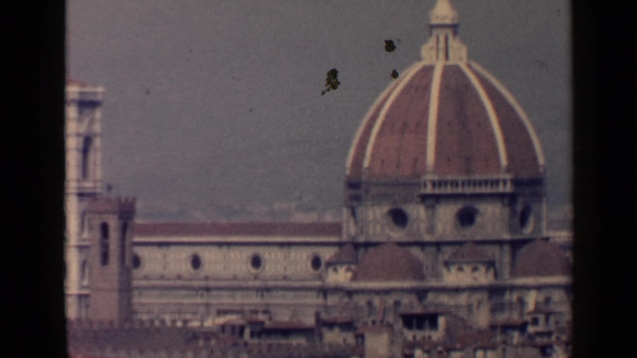 Florence Cathedral dome and bell tower above rooftops.