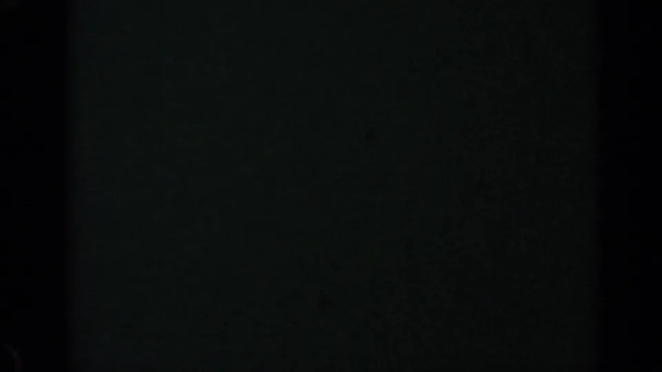 Underexposed 1960 8mm frame with only faint dark tonal variation visible in the contact sheet.