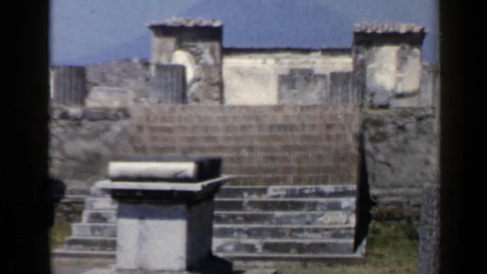 1960 8mm close view of masonry, worn steps, and a low stone block at an Italian archaeological site.