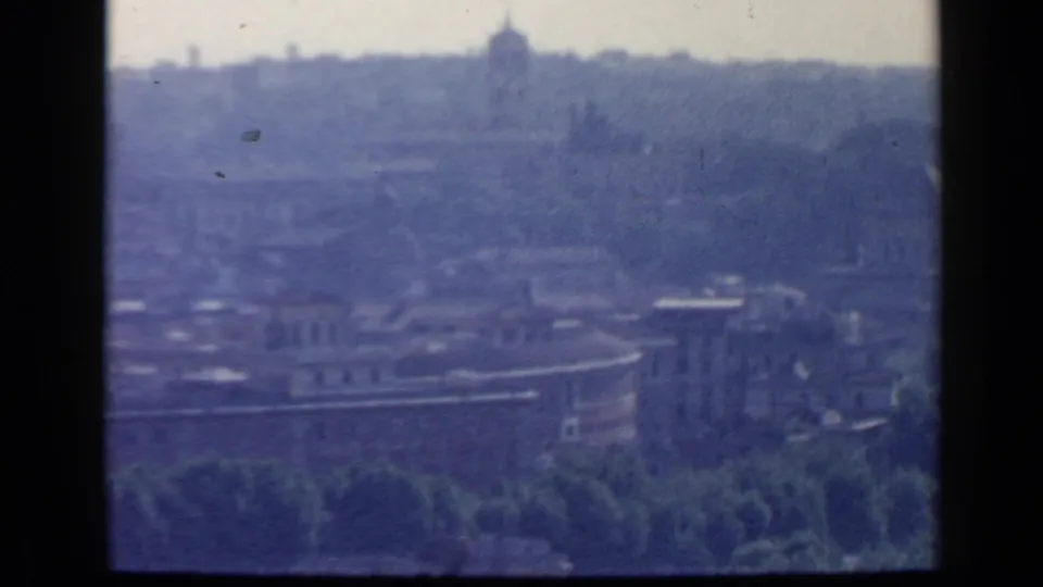 Soft 1960 Rome skyline frame with a curved foreground building, tree line, haze, and distant dome-like silhouettes.