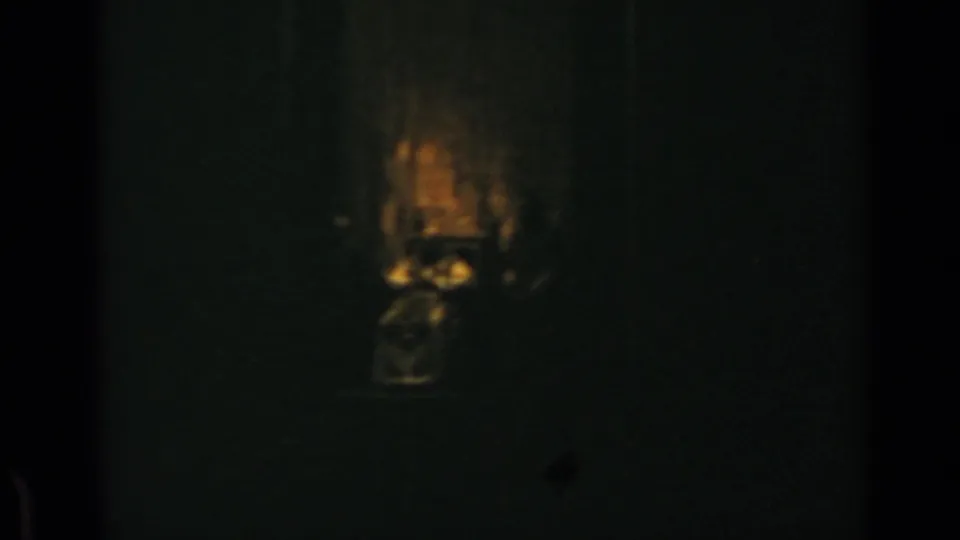 Low-light Rome frame showing a barely visible seated figure in a chair, identified by supplied metadata as Pope Paul VI.