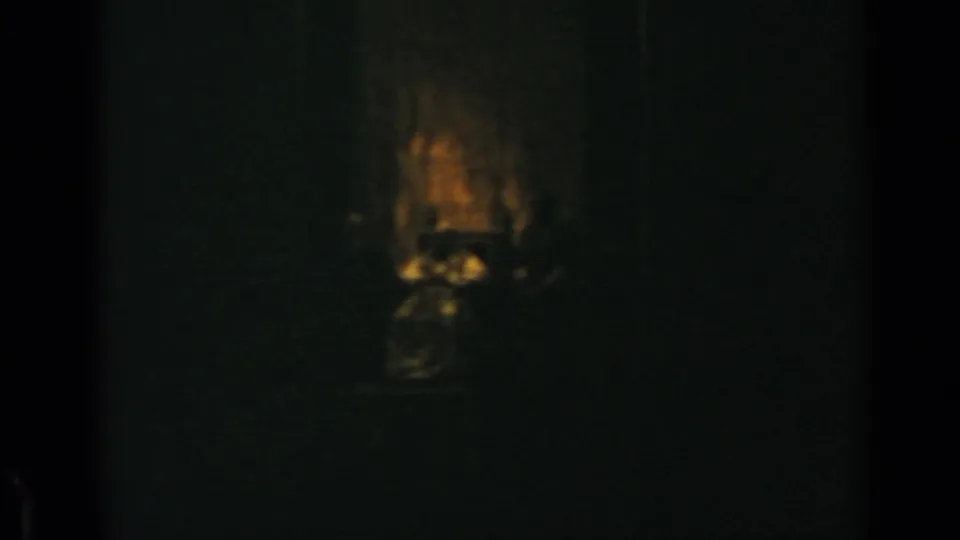 Underexposed 8mm frame from Rome with a dim seated figure in a chair, consistent with the supplied papal identification.