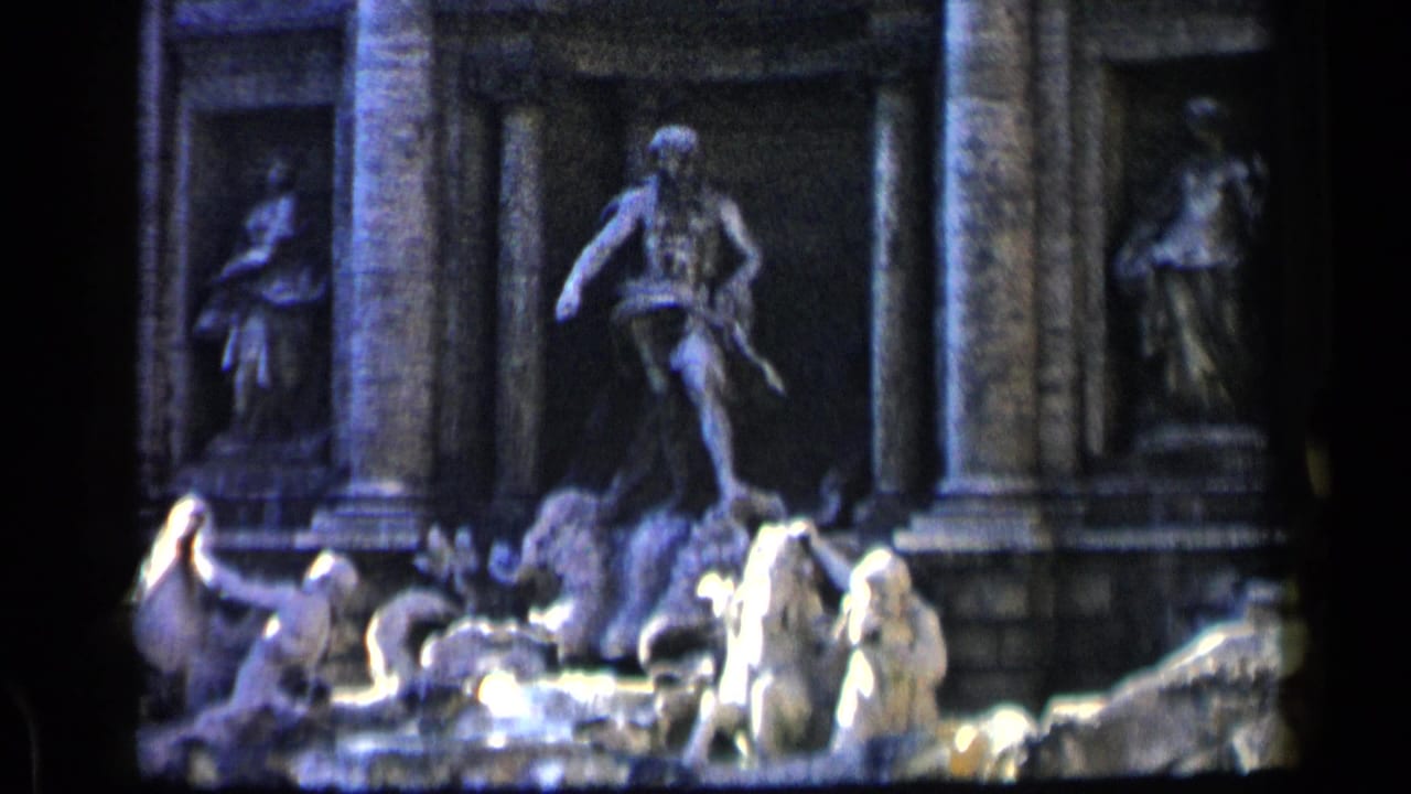 Trevi Fountain sculptures with water and visitors near the lower edge.