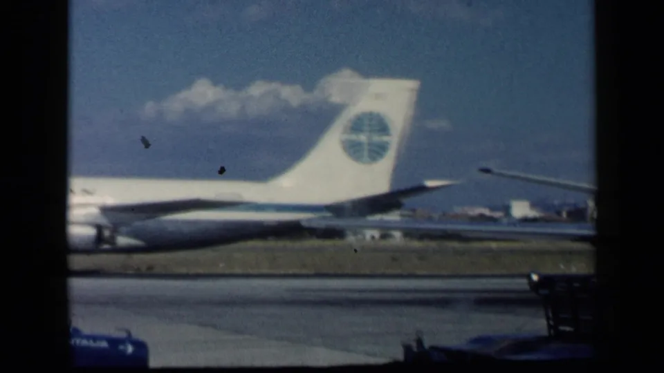 1960 archival 8mm frame showing the tail and rear fuselage of a Pan American aircraft during runway movement.