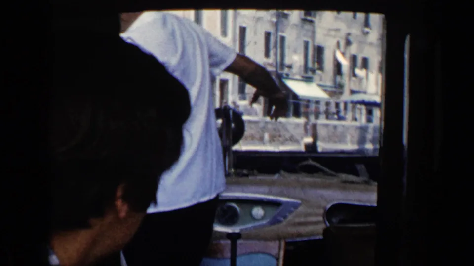 A 1960 Venice travel frame shows passengers in the foreground with canal boats and multi-story buildings outside.