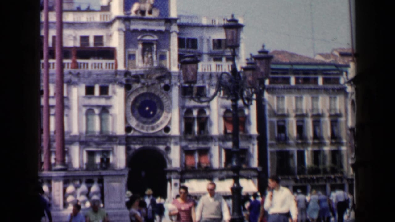 Venetian square with pedestrians and historic facades, including a clock-like round feature.