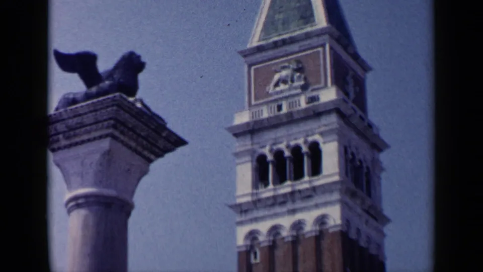 1960 Venice frame with the winged lion column in the foreground and the Campanile di San Marco behind it.