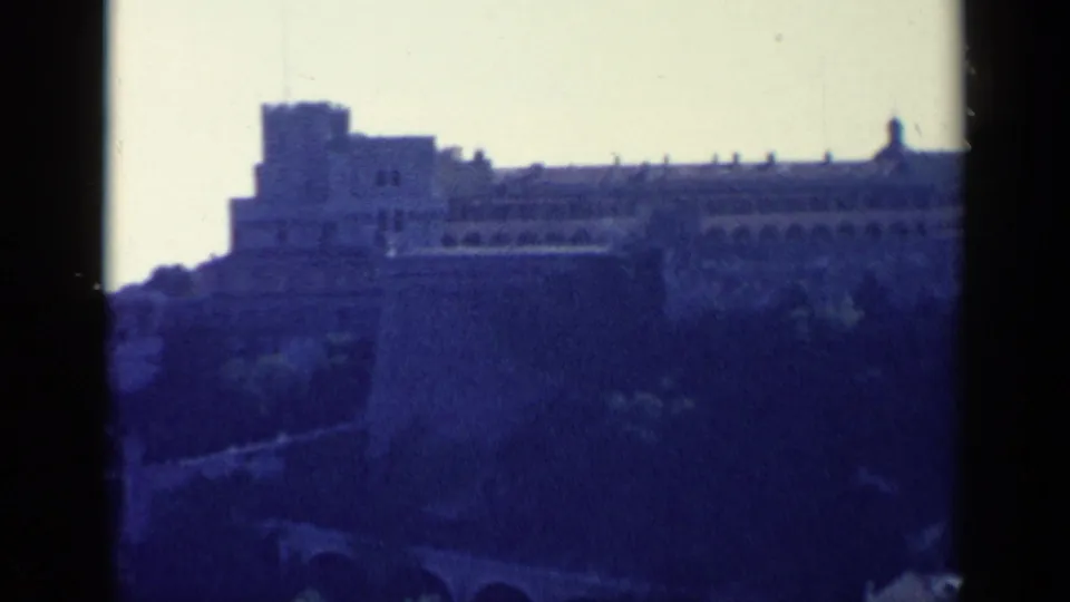 A distant hilltop fortification in Venice, Italy metadata, with crenellated walls and heavy 8mm color shift.