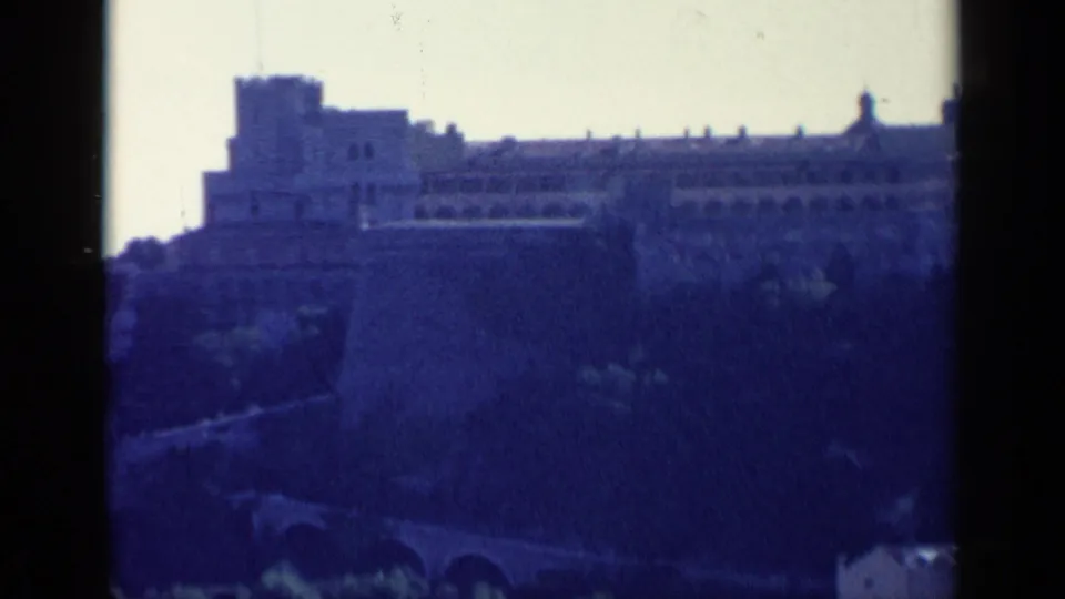 Soft-focus 8mm view of a large stone fortification above hillside arches, identified by metadata as Venice, Italy.