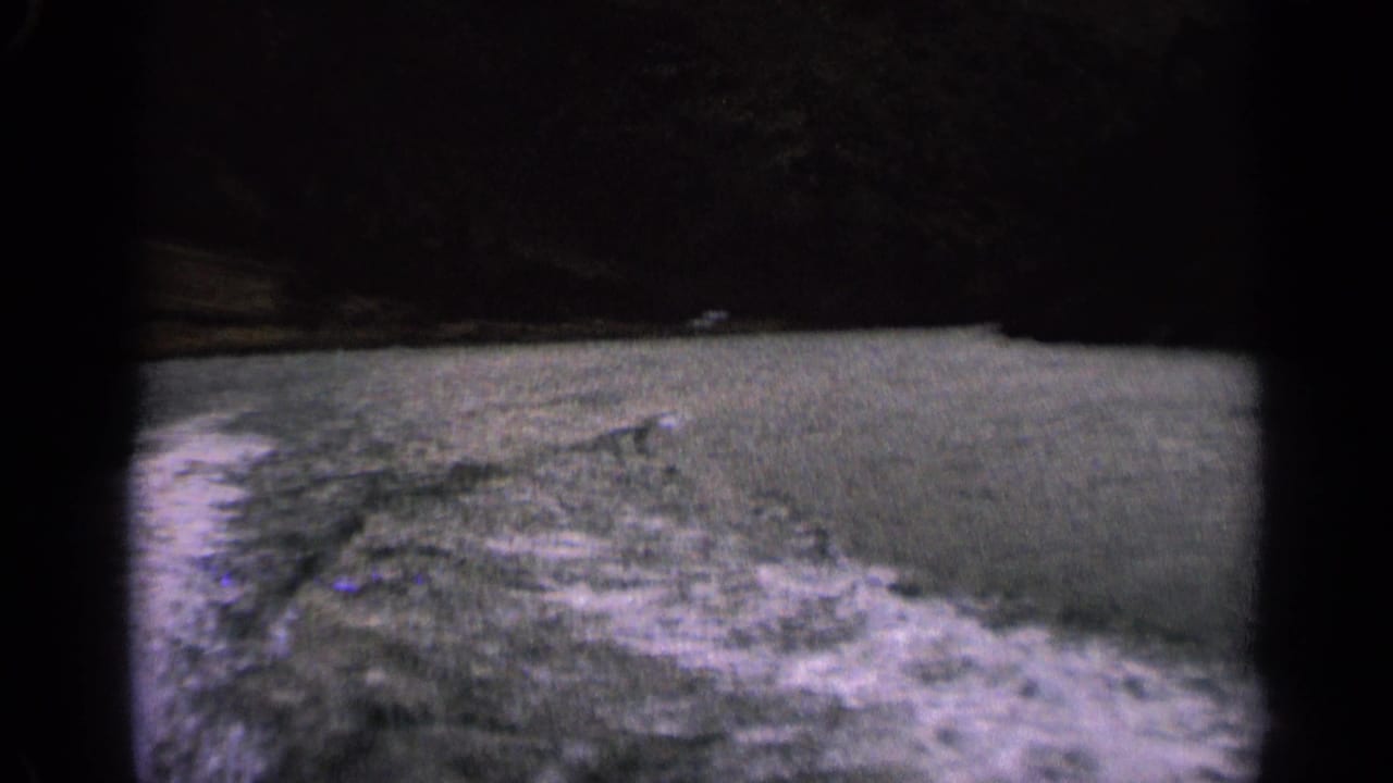 Blurred choppy river water and foamy wake seen from a moving boat.