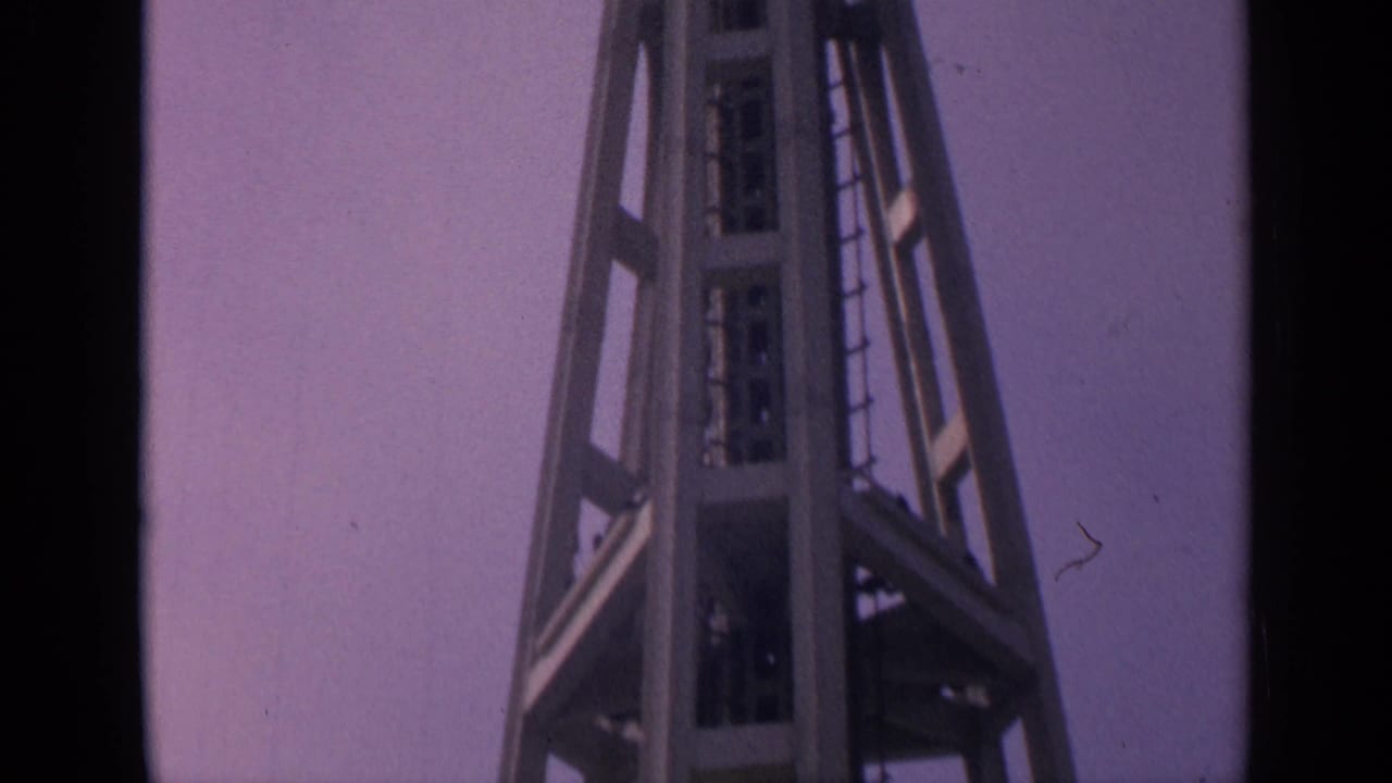 Steel tower framework fills the frame with sky behind it.