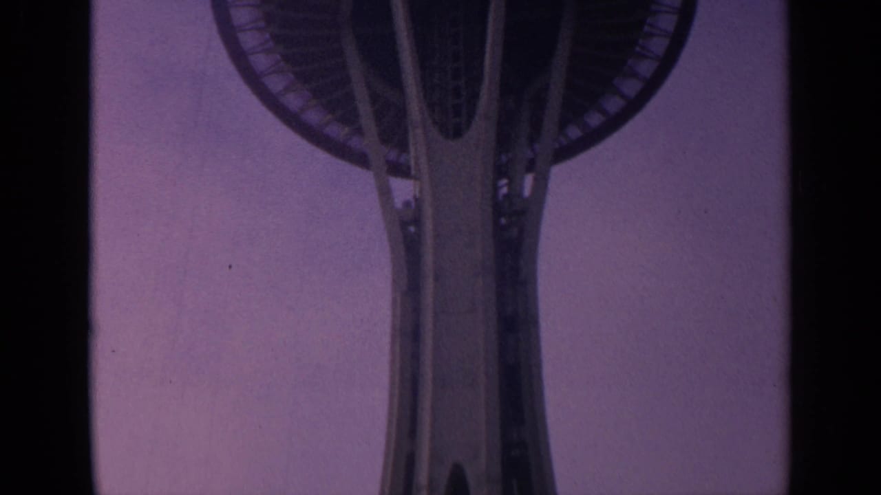 Upper Space Needle structure framed from below with the deck partly visible.