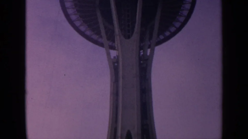 1963 Seattle Space Needle seen from below, with the tower shaft and part of the saucer-shaped deck near the top edge.