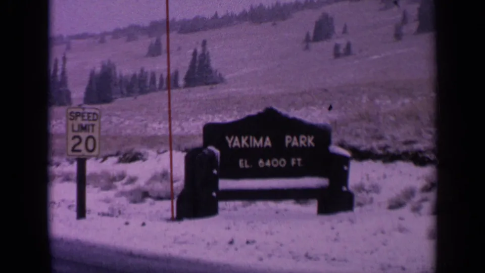 1963 Washington home-movie frame of the Yakima Park sign in a snowy mountain-park setting.