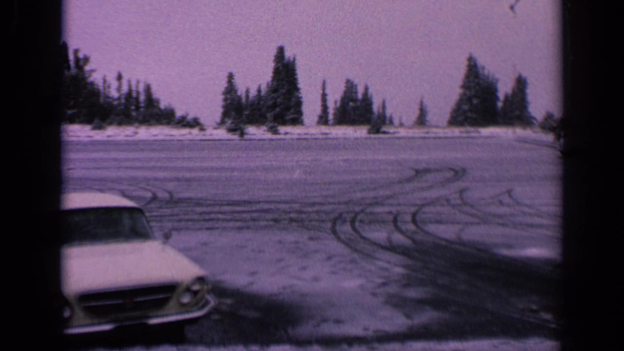 Final frame shows the white car partly cropped at lower left, with frozen roadway, looping tire tracks, and evergreen trees in Washington.