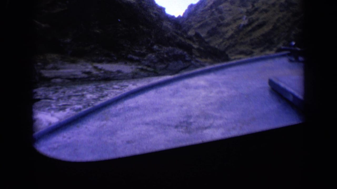 1963 Washington 8mm view from inside a boat traveling down a narrow river through a rugged mountain canyon.