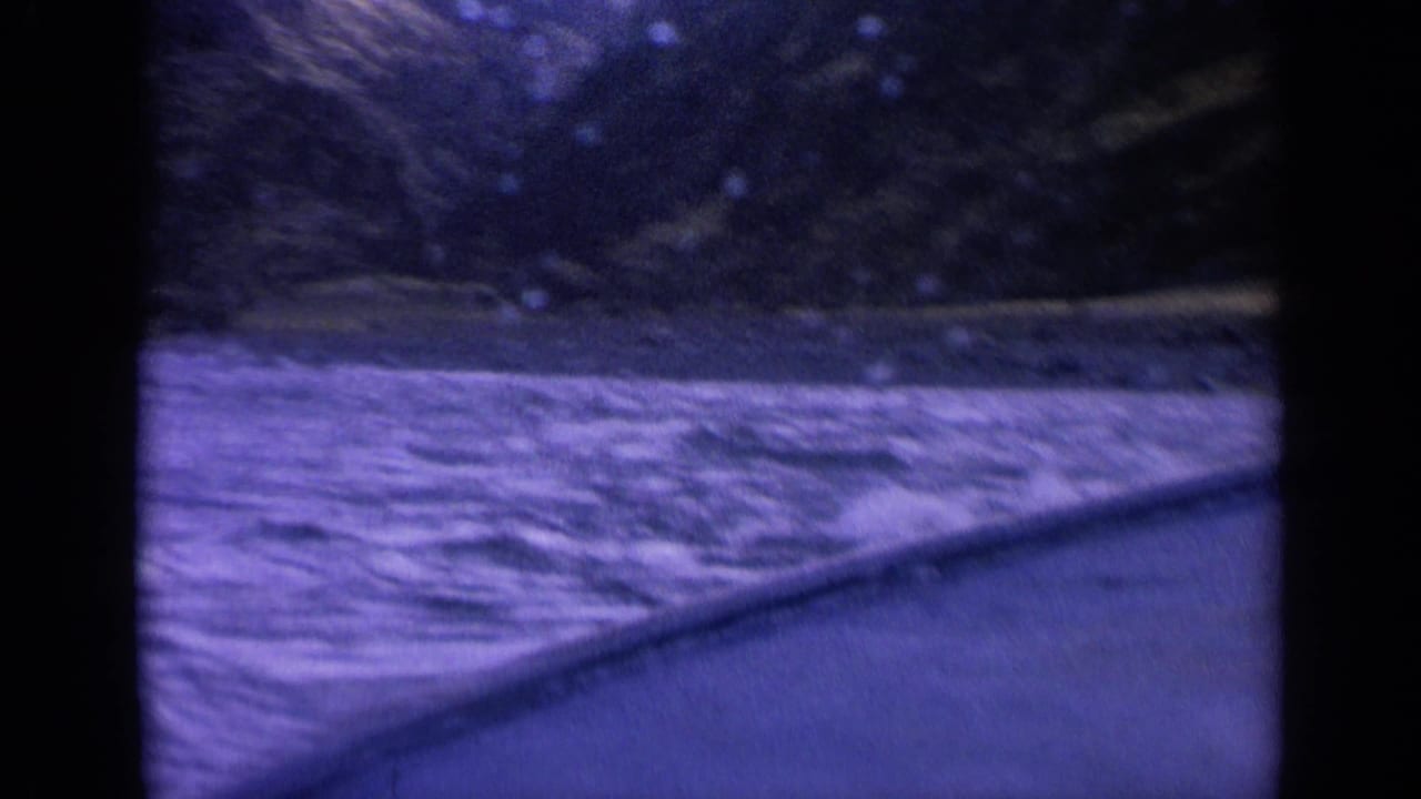 Forward-looking 8mm boat perspective on turbulent water and shadowed mountain terrain in Washington.
