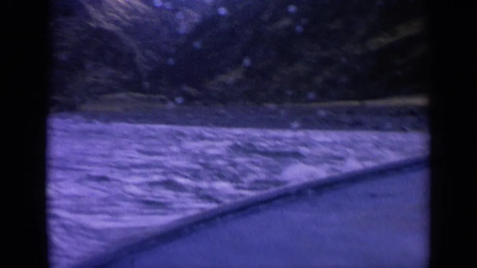 Forward-looking 8mm boat perspective on turbulent water and shadowed mountain terrain in Washington.