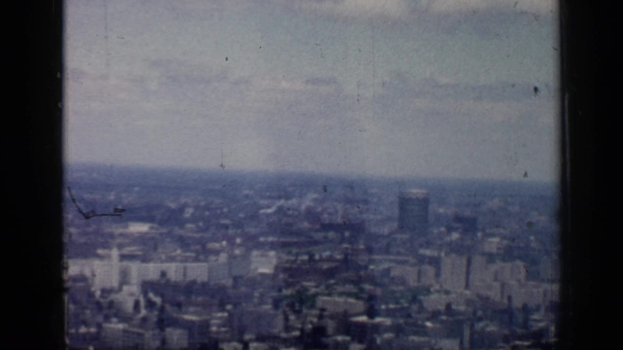 Soft elevated view across Chicago skyline with distant towers and a hazy sky.