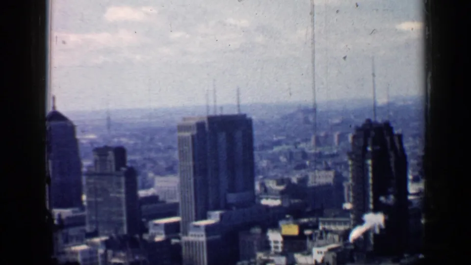 1957 Chicago downtown skyline with prominent high-rises, dense blocks, and a pale, slightly hazy sky.