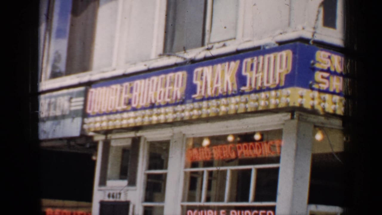 Double Burger Snak Shop storefront with blue and yellow marquee and neon window signs.