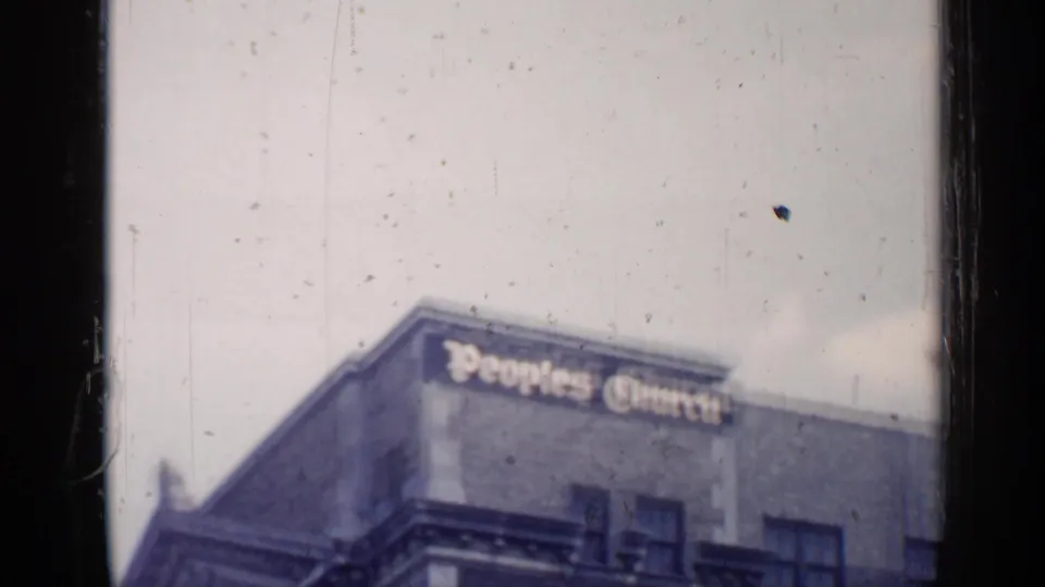1957 Chicago view of the upper Peoples Church building, showing roofline, brick wall, windows, and large exterior lettering.