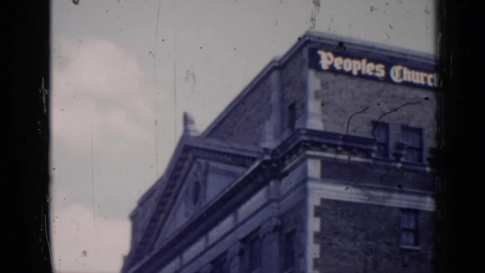 1957 Chicago angled view of the Peoples Church building, showing the sign, brick upper wall, windows, and ornate architectural details.